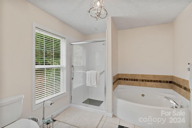 bathroom with tile patterned floors, a textured ceiling, plus walk in shower, and an inviting chandelier