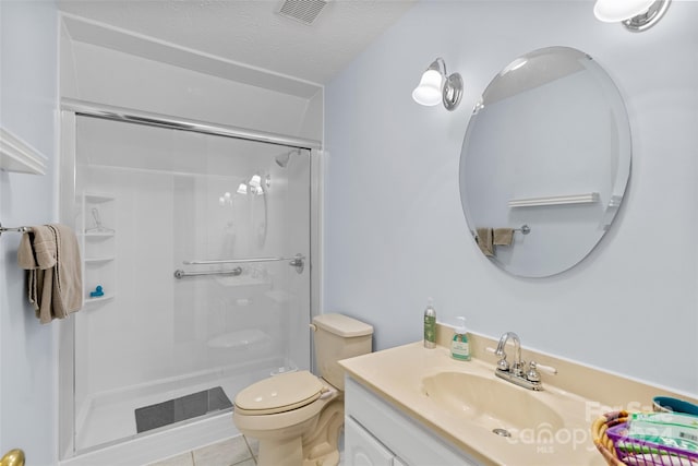 bathroom with vanity, tile patterned floors, toilet, a textured ceiling, and an enclosed shower