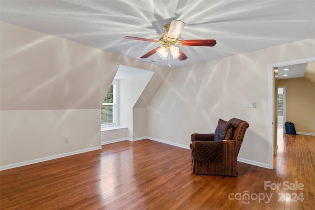 bonus room featuring a textured ceiling, hardwood / wood-style flooring, vaulted ceiling, and ceiling fan