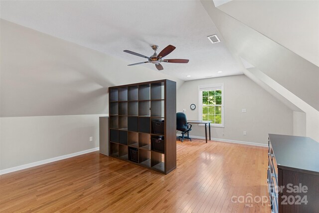 home office with ceiling fan, vaulted ceiling, and light wood-type flooring