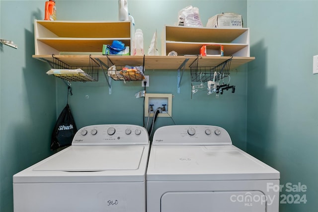 clothes washing area with washing machine and dryer