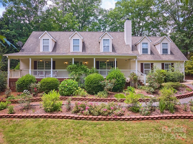 cape cod-style house featuring a porch and a front lawn