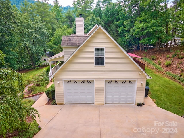 view of home's exterior with a lawn and a garage