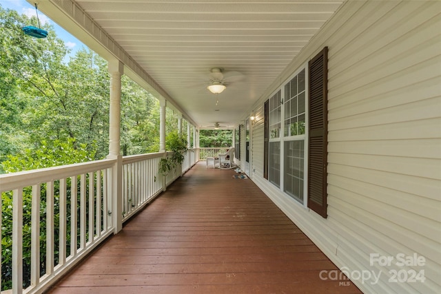 wooden deck featuring ceiling fan