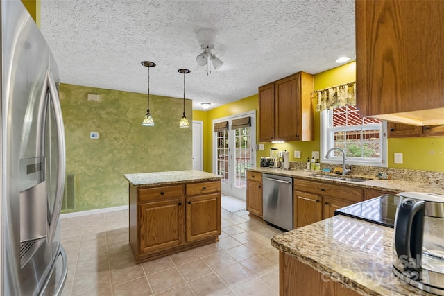 21 Farm Valley Ct, Weaverville, NC 28787 - kitchen with appliances with stainless steel finishes, a sink, brown cabinetry, plenty of natural light, and a textured ceiling