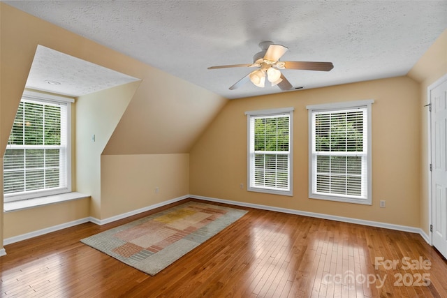21 Farm Valley Ct, Weaverville, NC 28787 - bonus room with hardwood / wood-style flooring, baseboards, plenty of natural light, a textured ceiling, and lofted ceiling