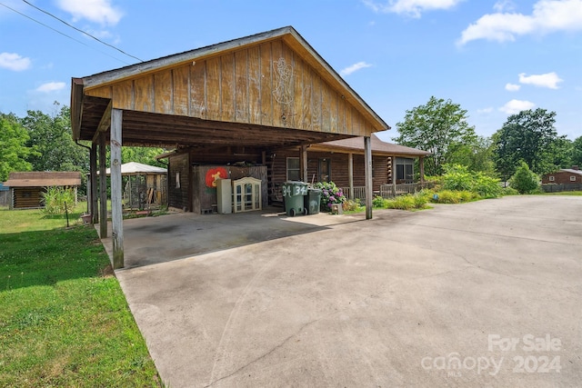 view of vehicle parking featuring a carport and a yard