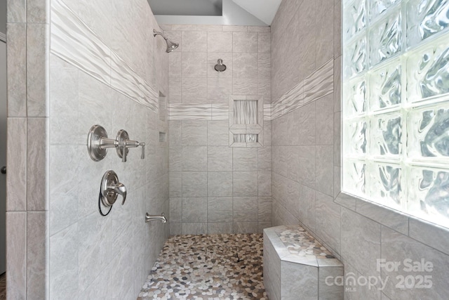 bathroom with a tile shower