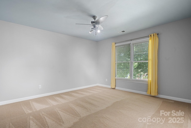 spare room featuring light carpet and ceiling fan