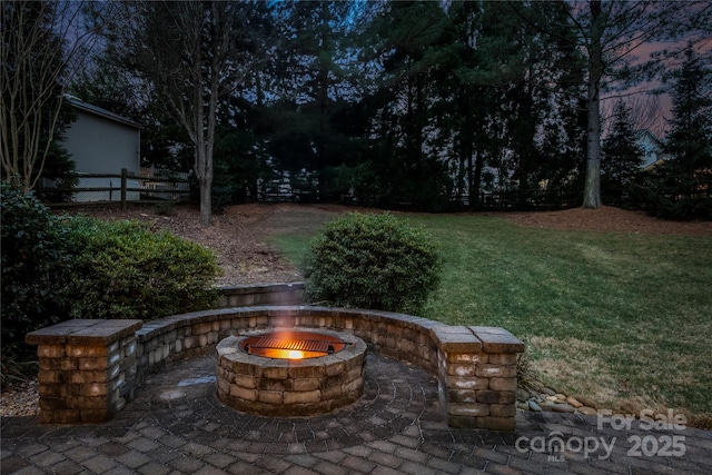 yard at dusk with a fire pit and a patio