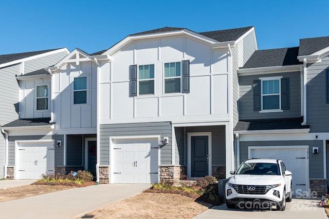 3820 Shider Ln, Kannapolis, NC 28081 - view of front facade featuring an attached garage, driveway, stone siding, board and batten siding, and roof with shingles