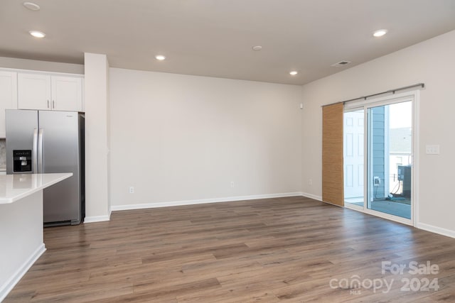 3820 Shider Ln, Kannapolis, NC 28081 - kitchen with stainless steel fridge with ice dispenser, wood finished floors, light countertops, recessed lighting, and white cabinets