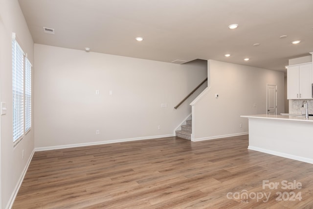 unfurnished living room featuring light hardwood / wood-style flooring