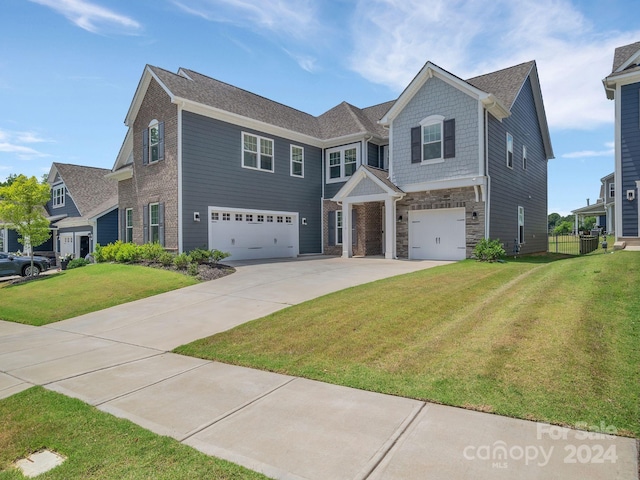 view of front of home with a garage and a front lawn