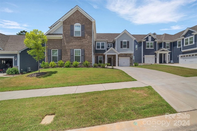 view of front of property with a garage and a front lawn