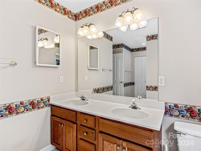 bathroom featuring toilet and vanity