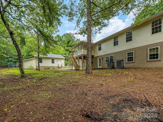 back of property with a wooden deck and central AC unit