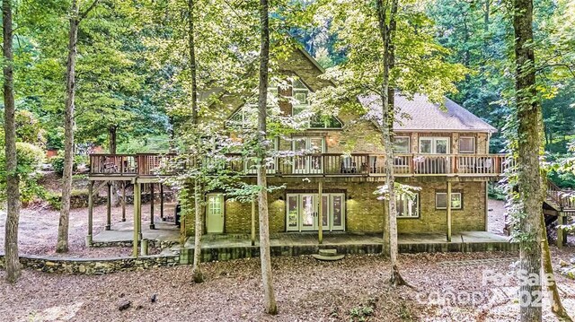 rear view of house featuring a patio area, french doors, and a deck