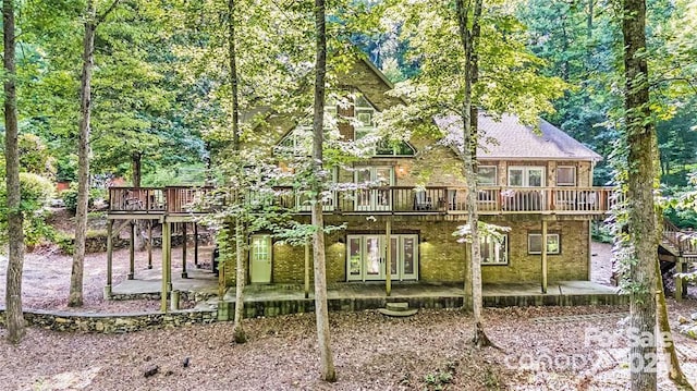 rear view of house featuring a patio area, french doors, and a deck