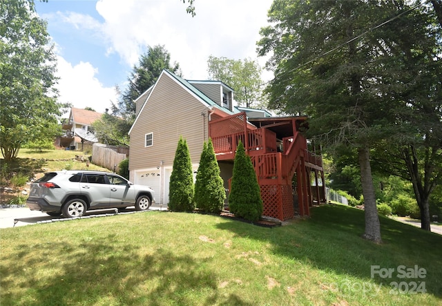 view of home's exterior with a garage, a yard, and a deck