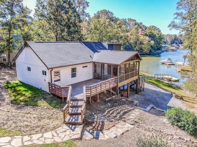 back of house featuring a sunroom and a deck with water view