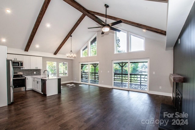 kitchen featuring sink, high vaulted ceiling, dark wood-type flooring, and appliances with stainless steel finishes