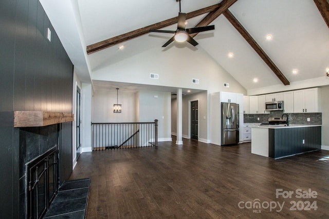 unfurnished living room with dark hardwood / wood-style flooring, beamed ceiling, high vaulted ceiling, and a tiled fireplace