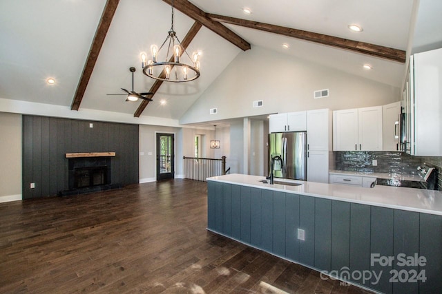 kitchen featuring dark hardwood / wood-style flooring, stainless steel appliances, beam ceiling, pendant lighting, and white cabinets