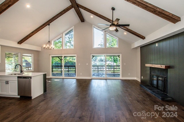 unfurnished living room featuring a tiled fireplace, sink, high vaulted ceiling, and dark hardwood / wood-style floors