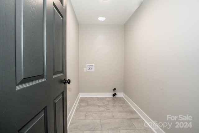 clothes washing area featuring hookup for a washing machine and light tile patterned floors