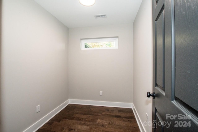 unfurnished room with dark hardwood / wood-style flooring