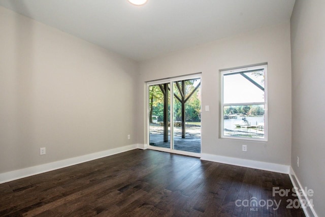 empty room with dark hardwood / wood-style floors