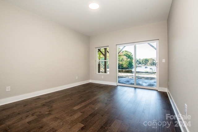 empty room with dark wood-type flooring