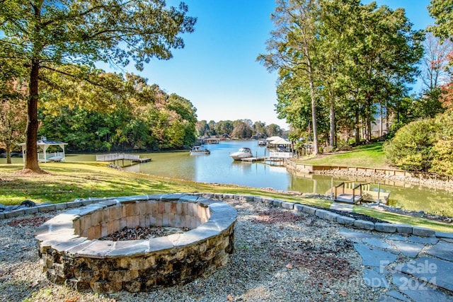 view of yard with a water view and a fire pit