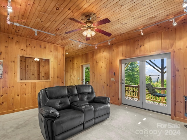 carpeted living room with track lighting, ceiling fan, and wood ceiling