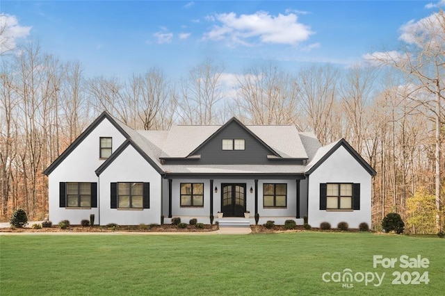 modern farmhouse style home with a front lawn