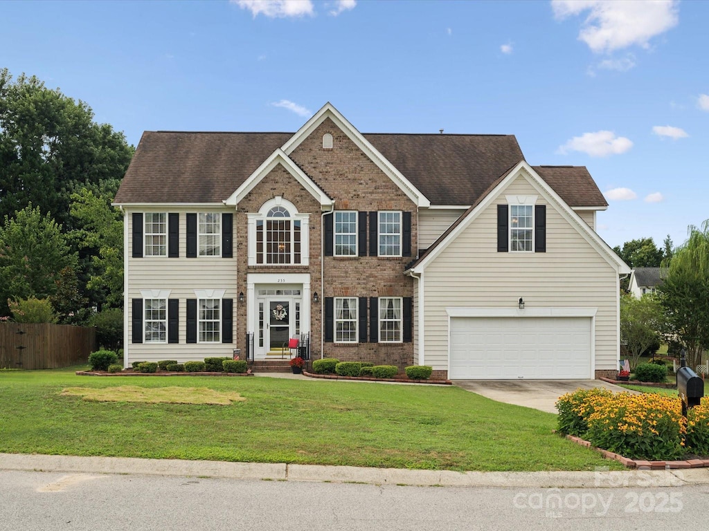 colonial-style house with a garage and a front yard