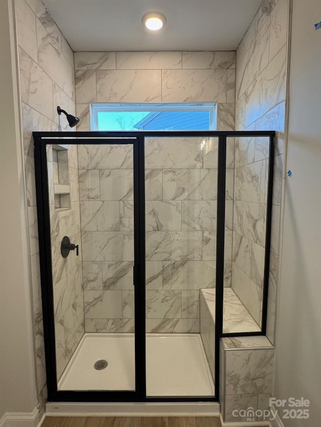 bathroom with a shower with shower door