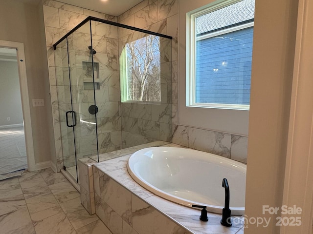 bathroom featuring plus walk in shower and plenty of natural light