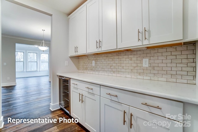 kitchen with wine cooler, backsplash, dark hardwood / wood-style flooring, and white cabinetry