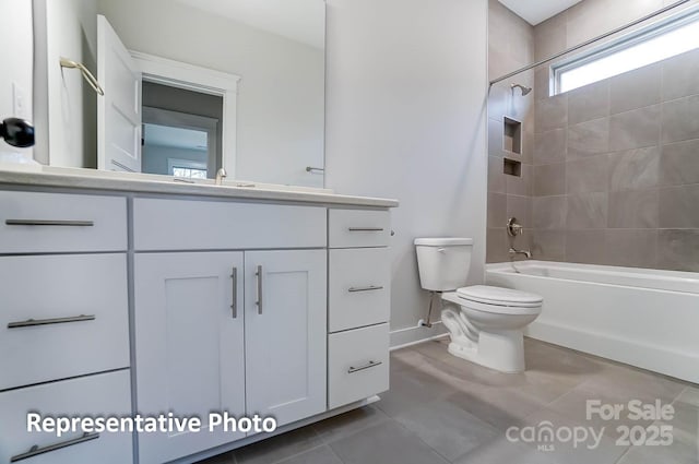 full bathroom featuring tile patterned floors, toilet, vanity, and tiled shower / bath