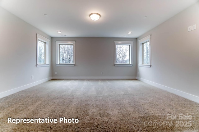 carpeted empty room featuring a healthy amount of sunlight