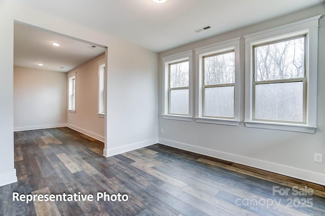 spare room featuring dark hardwood / wood-style flooring