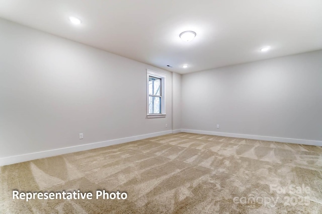 spare room featuring light carpet