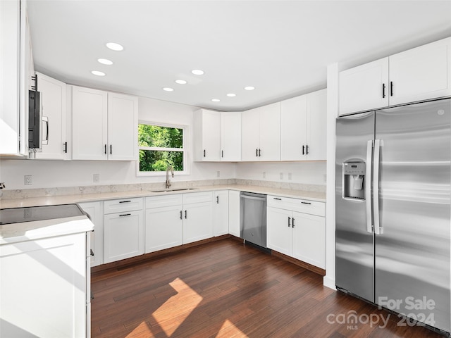 kitchen featuring white cabinetry, sink, appliances with stainless steel finishes, and dark wood-type flooring