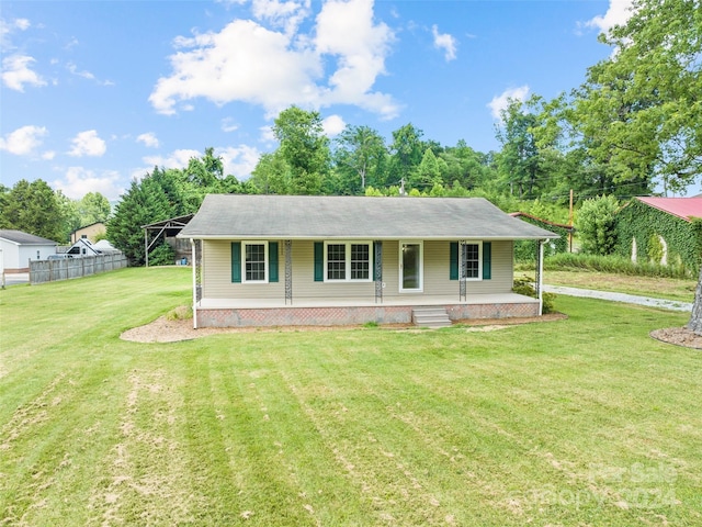 ranch-style home with covered porch and a front yard