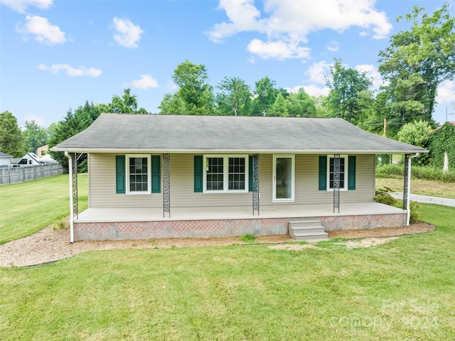 ranch-style home with a front yard and a porch