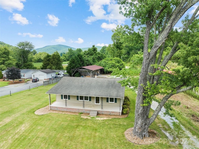 exterior space with a mountain view and a lawn