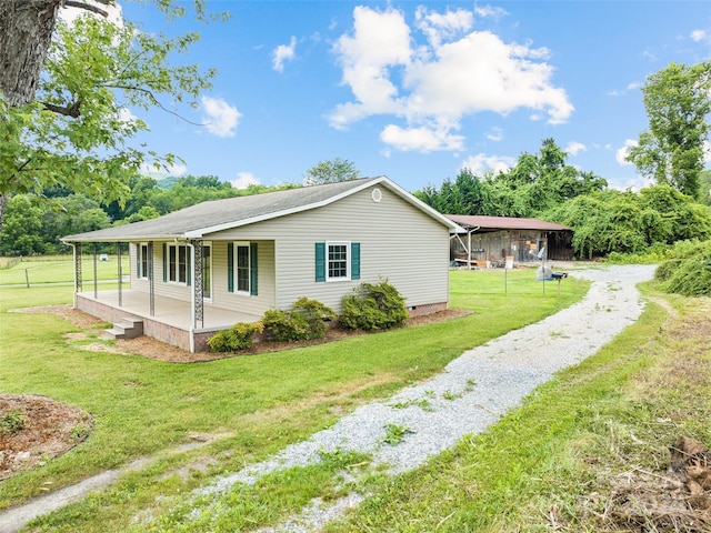 view of property exterior with a porch and a yard