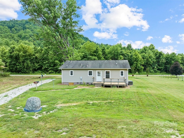 view of front of home featuring a deck and a front yard